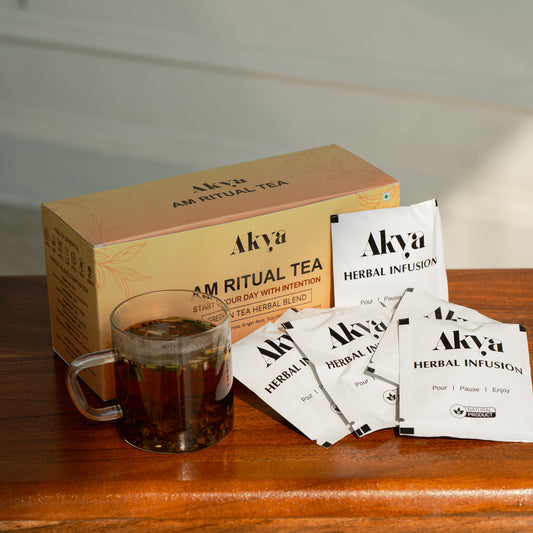Akya AM Ritual Tea set with a cup of tea and tea bags on a wooden surface.